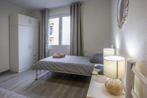 a small bedroom with a bed and a window at House & Garden in Kavála