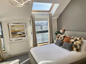 a bedroom with a bed and a large window at Edinburgh Penthouse 101 in Edinburgh
