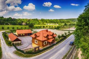 an aerial view of a house with a car on a road at Ranczo w Dolinie - Bałtów in Bałtów