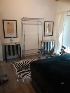 a bedroom with a zebraebra rug on the floor at Apartment in den bayerischen Alpen, für Naturliebhaber in Schneizlreuth +23 photos