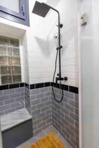 a bathroom with a shower with blue tiles at SKG City Cabin in Thessaloniki