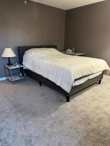 a bedroom with a bed and a side table at Condo Townhome - Cleveland Lake Area 