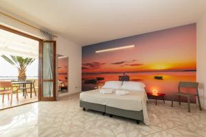 A bed or beds in a room at Resort Santa Maria Hotel