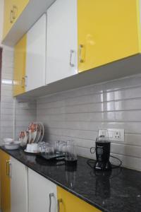a kitchen with a counter with glasses on it at ROYAL RIDGE HOME STAYS in Tirupati