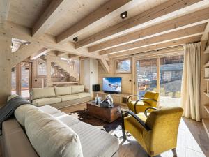 a living room with a couch and chairs and a tv at Chalet Val-d'Isère, 6 pièces, 11 personnes - FR-1-567-69 in Val-d'Isère