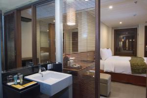 Postel nebo postele na pokoji v ubytování Savvoya Hotel Seminyak