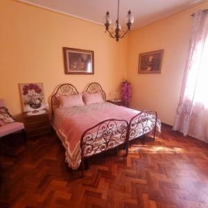 a bedroom with a bed with pink pillows on it at Guest House San Francesco Garden in Rapolano Terme