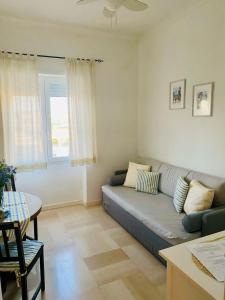 a living room with a couch and a table at Eden Apartment in Anacapri