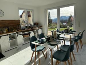 a kitchen with a table and chairs in a room at Designpension Classicidyll - Sennhütte 3 in Wernigerode