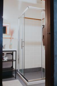 a shower with a glass door in a bathroom at 島中大厝 in Jinhu