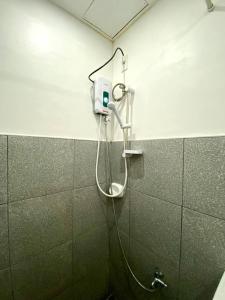 a shower in a bathroom with a shower head at TopBudz Hostel Panagsama Moalboal Couple in Moalboal