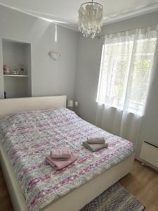 a bedroom with a bed with two towels on it at TENA in Kukuljanovo
