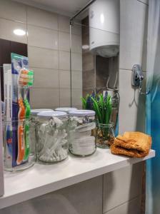 a counter with glass jars on a shelf in a kitchen at Dionis in Veliko Gradište