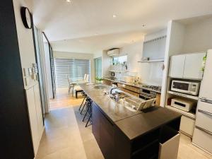 a kitchen with a sink and a counter top at Accessible Four-Bedroom House near Kuzuha Station! in Hirakata