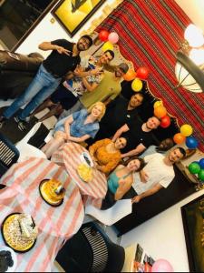 a group of people posing for a picture at a party at Dreams beach hostel in Dubai