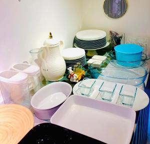 a table with bowls and plates and a vase at Dreams beach hostel in Dubai