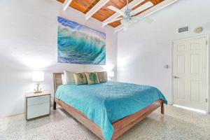 um quarto com uma cama e um quadro na parede em Beachfront Getaway in Siesta Key em Siesta Key