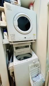 a washer and dryer sitting in a refrigerator at Accessible Four-Bedroom House near Kuzuha Station! in Hirakata