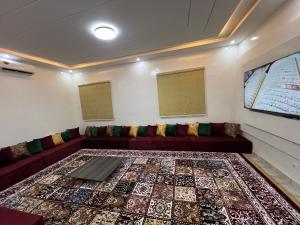 a living room with a couch and a rug at Résidence Les Oliviers by Jad Inn in Nouakchott