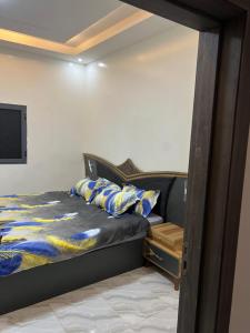 a bedroom with a bed and a flat screen tv at Résidence Les Oliviers by Jad Inn in Nouakchott