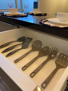 a drawer with several utensils in a kitchen at Casa em condomínio fechado in Cuiabá