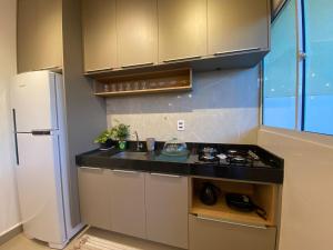 uma cozinha com um fogão e um frigorífico em Casa em condomínio fechado em Cuiabá