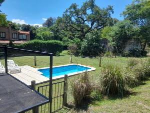 a swimming pool in a yard with a fence at SOBRE RIELES VAGON in San Lorenzo