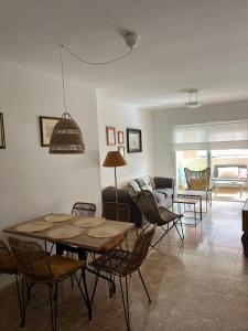salon ze stołem, krzesłami i kanapą w obiekcie Apto Calpe con piscina. No uses coche vacaciones. w mieście Calpe