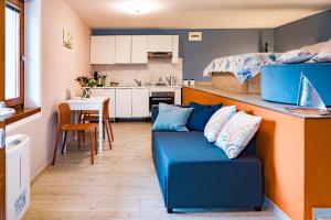 salon z niebieską kanapą i kuchnią w obiekcie Ca de l'Angelon -- Vittoria house w Brenzone sul Garda