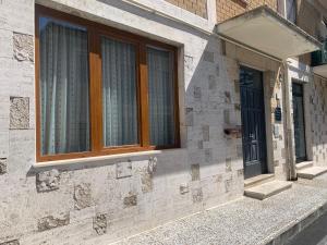 a stone building with windows on the side of it at L'appartamentino in Montefiascone