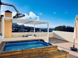 a swimming pool on the roof of a house at Casa da Pedreira in Vila Baleira