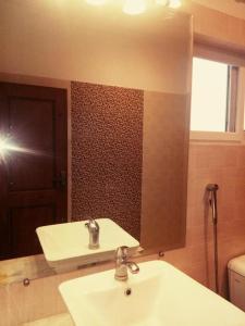 a bathroom with a white sink and a mirror at Royal Galaxy Bed & Breakfast E-11 Islamabad - For Families Only in Islamabad