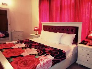 a bedroom with a bed with red roses on it at Royal Galaxy Bed & Breakfast E-11 Islamabad - For Families Only in Islamabad