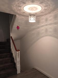 a hallway with a ceiling with a light and stairs at Springhome Newport in Newport