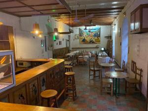 a restaurant with tables and chairs and a bar at HOTEL DU PALAIS in Saint-Louis