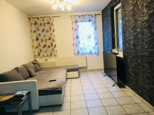 a living room with a couch and a window at Quiet beautiful apartment in Tuttlingen