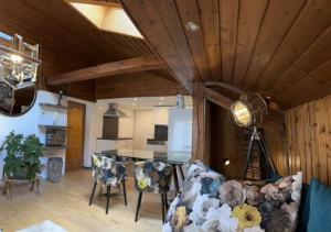 a kitchen and living room with a wooden ceiling at Haus Schmidhuber Wohnung 4 in Grossgmain