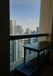 a table in a room with a view of a city at Urban Heaven, Luxury Hostel - JBR - Walk To Beach, Metro Station in Dubai