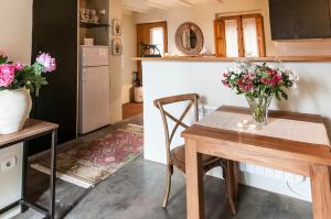 a kitchen with a table with a vase of flowers on it at El Racó de Madremanya - Adults only in Madremanya