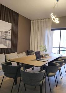 a dining room with a table with chairs and a laptop at Urban Heaven, Luxury Hostel - JBR - Walk To Beach, Metro Station in Dubai