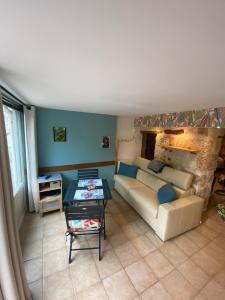 a living room with a couch and a table at And&Col Jardin ,terrasse & climatisation in Marseille