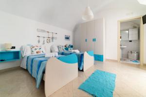 una camera da letto blu e bianca con un letto e un tappeto blu di Gioia Casa Vacanze by MONHOLIDAY a Monopoli
