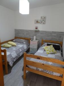 a bedroom with two beds and a night stand at Casa Vacanza Villa Giovanna in Valderice