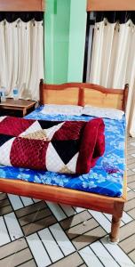 a bed with red pillows on it in a room at India Tours Only Smriti Homestay in Rongli
