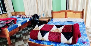 a bedroom with two beds and a table at India Tours Only Smriti Homestay in Rongli