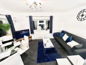 a living room with a couch and a table at Watford Central Luxury Serviced Accommodation in Watford