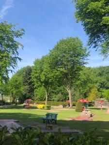 a park with a bench in the grass at Ferienhaus Anni in Bad Zwischenahn