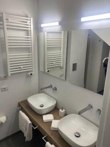 a white bathroom with a sink and a mirror at Luxury Loft 35 in Cagliari +19 photos