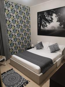 ElyCry B&b في Gli Angeli: غرفة نوم بسرير مع صورة كبيرة على الحائط
