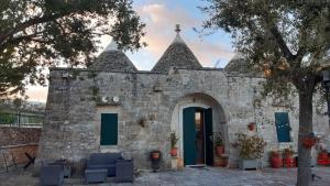 an old stone building with a blue door at La magia del trullo in Martina Franca
